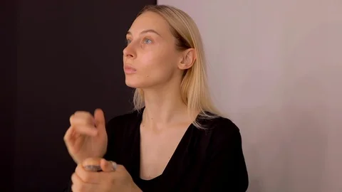 Young caucasian model applying professional makeup. beautiful woman applying Stock Footage 113856413