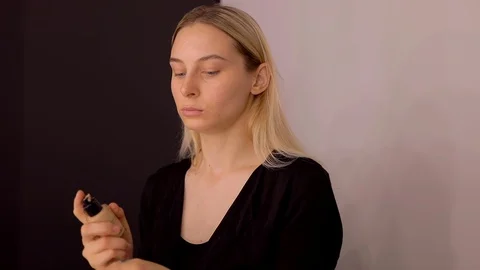 Young caucasian model applying professional makeup. beautiful woman applying Stock Footage 113856829