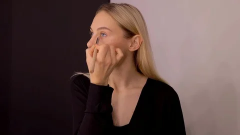 Young caucasian model applying professional makeup. beautiful woman applying Stock Footage 113865718