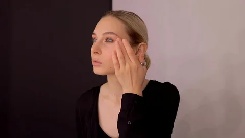 Young caucasian model applying professional makeup. beautiful woman applying Stock Footage 113868355