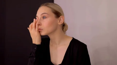 Young caucasian model applying professional makeup. beautiful woman applying Stock Footage 113913043