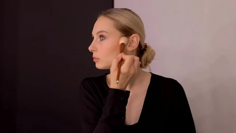 Young caucasian model applying professional makeup. beautiful woman applying Stock Footage 113913478
