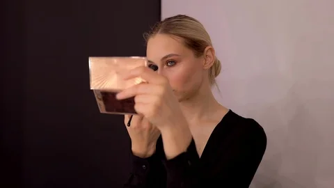 Young caucasian model applying professional makeup. beautiful woman applying Stock Footage 113913857