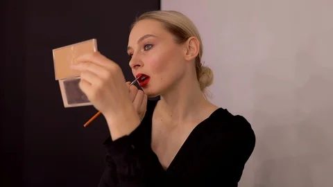 Young caucasian model applying professional makeup. beautiful woman applying Stock Footage 113914914