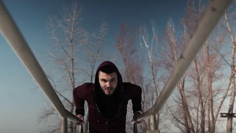 Young caucasian or middle eastern man exercising on parallel bars Stock Footage 74877641