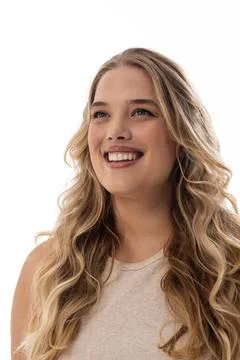 A young Caucasian plus-size model with white background looks up, copy space Stock Photos