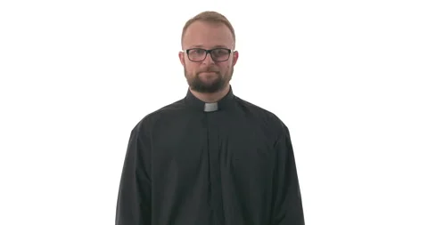 Young Caucasian priest checking if someone is watching him and showing a little Video stock 145260175