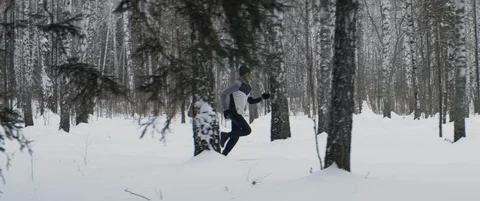Young Caucasian runner runs long distance in forest or park. Sprinting fast Stock Footage 120299113