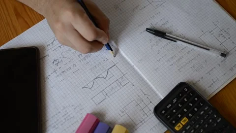 Young caucasian student doing a math assignment with pen and calculator. 스톡 동영상 211343099