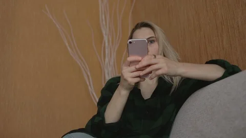 Young caucasian student sitting at sofa use smartphone at loft social media 5g Stock Footage 113910238