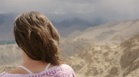 Young caucasian woman looking down from top of mountain Stock Footage 61155274