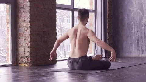 Young caucasian yoga master practicing yoga near a window. Stock Footage 71239342