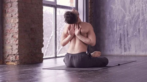 Young caucasian yoga master practicing yoga near a window.  Stock Footage 71239406