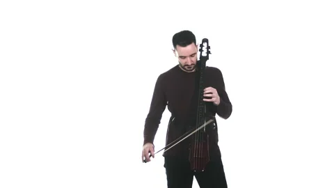 Young cellist playing an electric cello. Medium long shot. Isolated Stock Footage 134494860