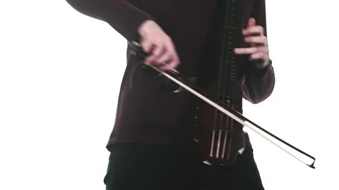 Young cellist playing an electric cello. Medium long shot. Isolated Stock Footage 134494902