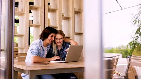 Young charming couple using laptop while sitting at cafe Video stock 89827852