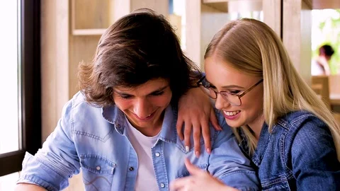 Young Charming Couple Using Tablet While Sitting Together And Drinking Coffee Stock Footage 89828362