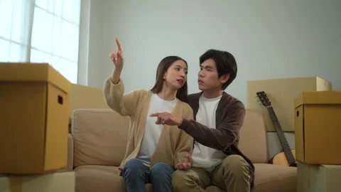 Young cheerful couple having conversation and smiling to each other after moving Stock Footage 283825923