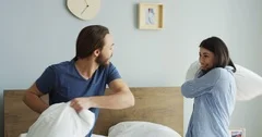 funny couple pillow fighting in bed slow, Stock Video