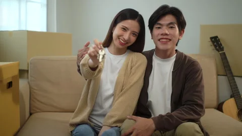 Young cheerful couple smiling to each other and looking at camera while girlfrie Stock Footage 283825307