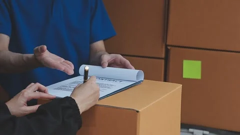 Young cheerful delivery man with parcel near car full of cardboard boxes, f.. Stock Footage 278839682