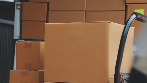 Young cheerful delivery man with parcel near car full of cardboard boxes, f.. Stock Footage 278839733