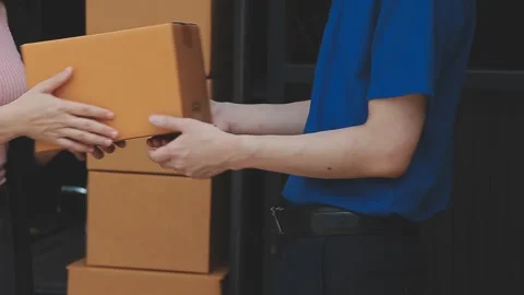 Young cheerful delivery man with parcel near car full of cardboard boxes, f.. Stock Footage 278839741