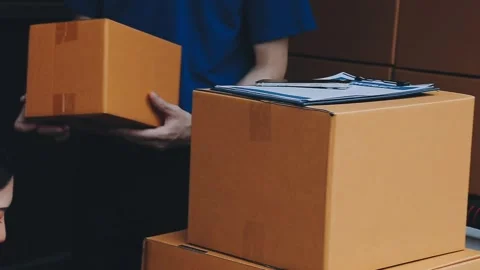 Young cheerful delivery man with parcel near car full of cardboard boxes, f.. Stock Footage 278958356