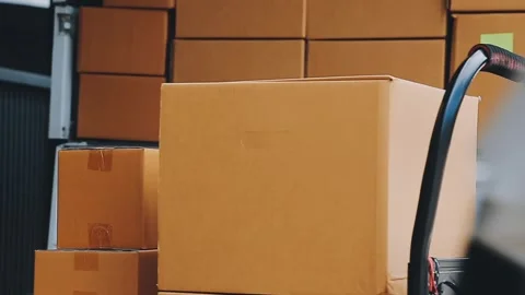 Young cheerful delivery man with parcel near car full of cardboard boxes, f.. Stock Footage 278958367