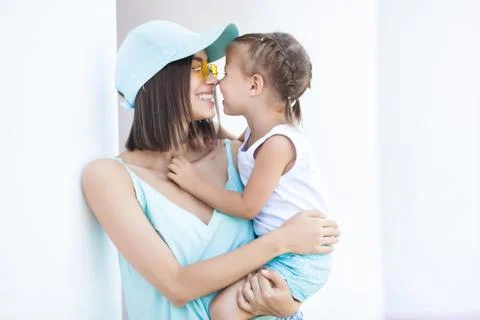 Young cheerful woman with her little daughter outdoors. Happy family together Stock Photos