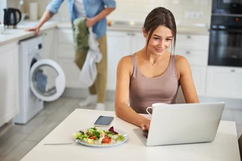 Young cheerful woman using computer for work Stock Photos
