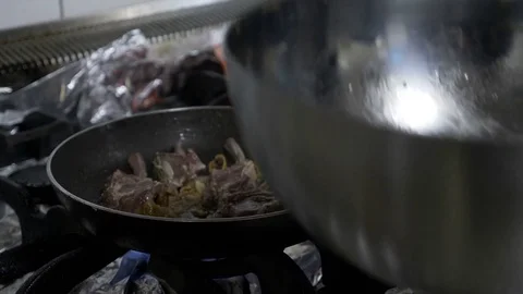 Young chef cooking lamb meat and exotic vegetables in luxury restaurant on th Stock Footage 81259011