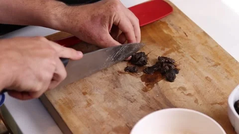 Young chef cutting inputs for a recipe Stock Footage 153771800