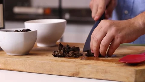 Young chef cutting inputs for a recipe Stock Footage 153771874