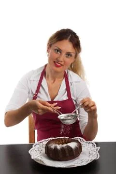 Young chef decorating a marble cake Stock Photos