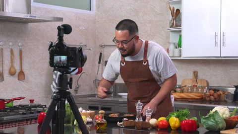 Young chef in kitchen shooting video food blog about cooking. Stock Footage 134419270