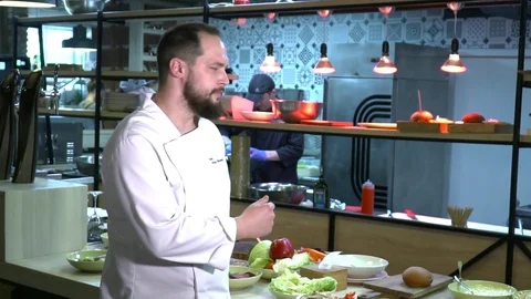 Young chef looking to the camera and smiling slow motion Stock Footage 77043357