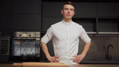 Young chef posing confidently in commercial kitchen Stock Footage 125474613