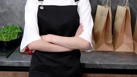 Young chef prepares for a culinary adventure in a cozy kitchen setting Video stock 296316615