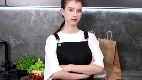 Young chef prepares for a culinary challenge in a modern kitchen setting Vídeo Stock 296317181
