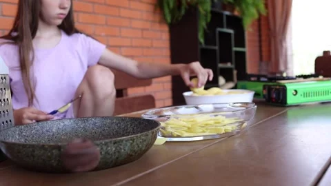 Young chef prepares fresh ingredients in a cozy kitchen environment Stock Footage 297359352