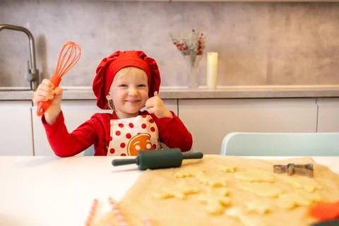 Young chef preparing cookies in a kitchen, showcasing creativity and joy du.. Foto stock