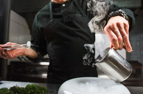 Young chef preparing modern molecular dish with liquid nitrogen Stock Photos
