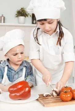 Young chef preparing vegetables in the kitchen Stock Photos