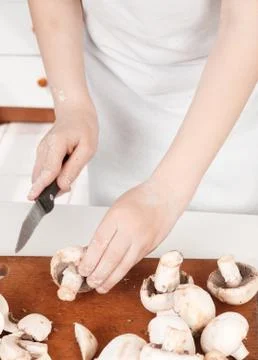 Young chef preparing vegetables in the kitchen Stock Photos