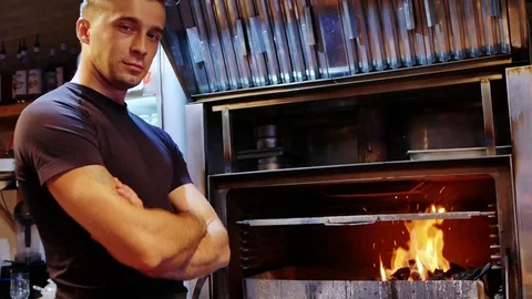 Young chef prides himself on his grill Stock Footage 78742945