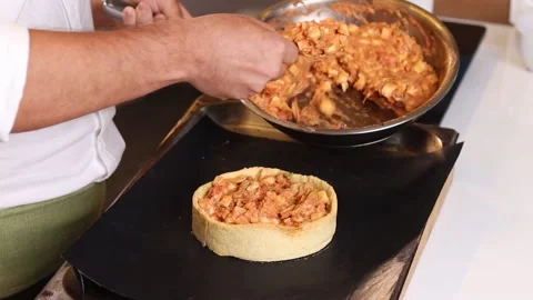 Young chef stuffing a delicious quiche Stock Footage 153771591