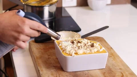Young chef using blowtorch to finalize a recipe Stock Footage 153771873