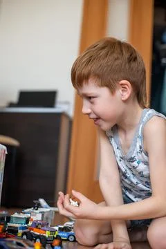Young child boy plays constructor at home on the floor. Preschool education.  Stock Photos
