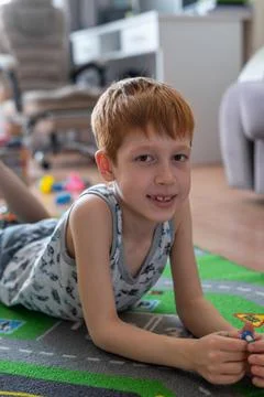 Young child boy plays constructor at home on the floor. Preschool education.  Stock Photos
